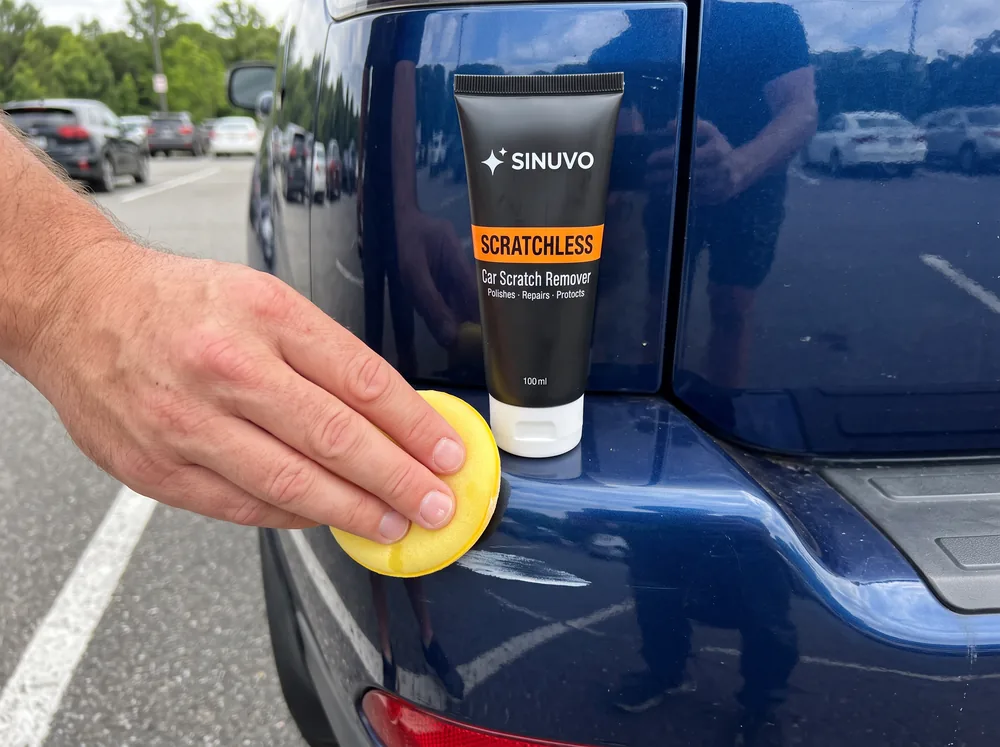 Rubbing a bumper scuff with the Scratchless foam pad; half the scuff is already gone